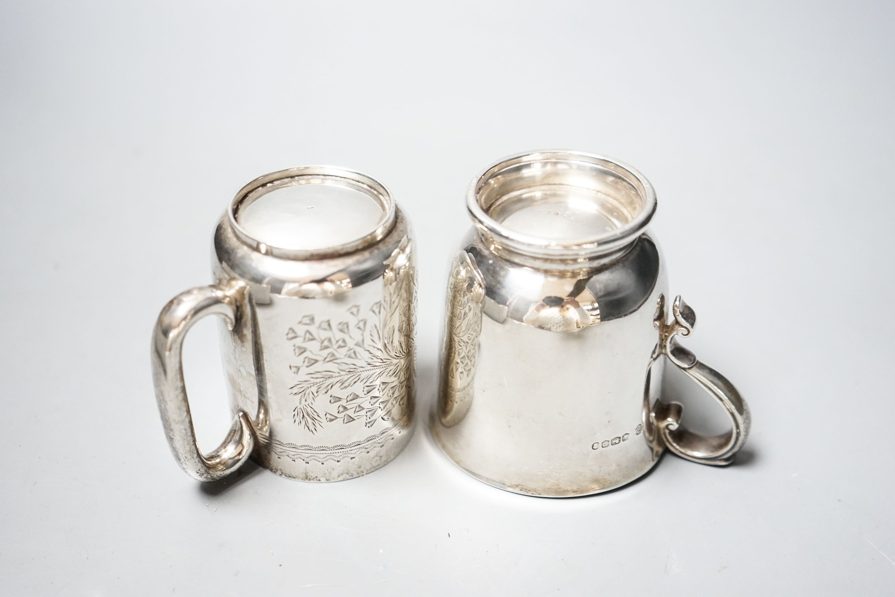 An Edwardian engraved silver christening mug, Chester, 1906, 73mm and a later silver mug, 6.5oz.